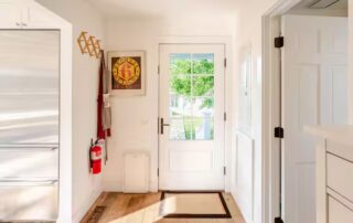 the back door by the kitchen leads to a shady deck at Sunset Farm Stay vacation rental in Crozet Virginia