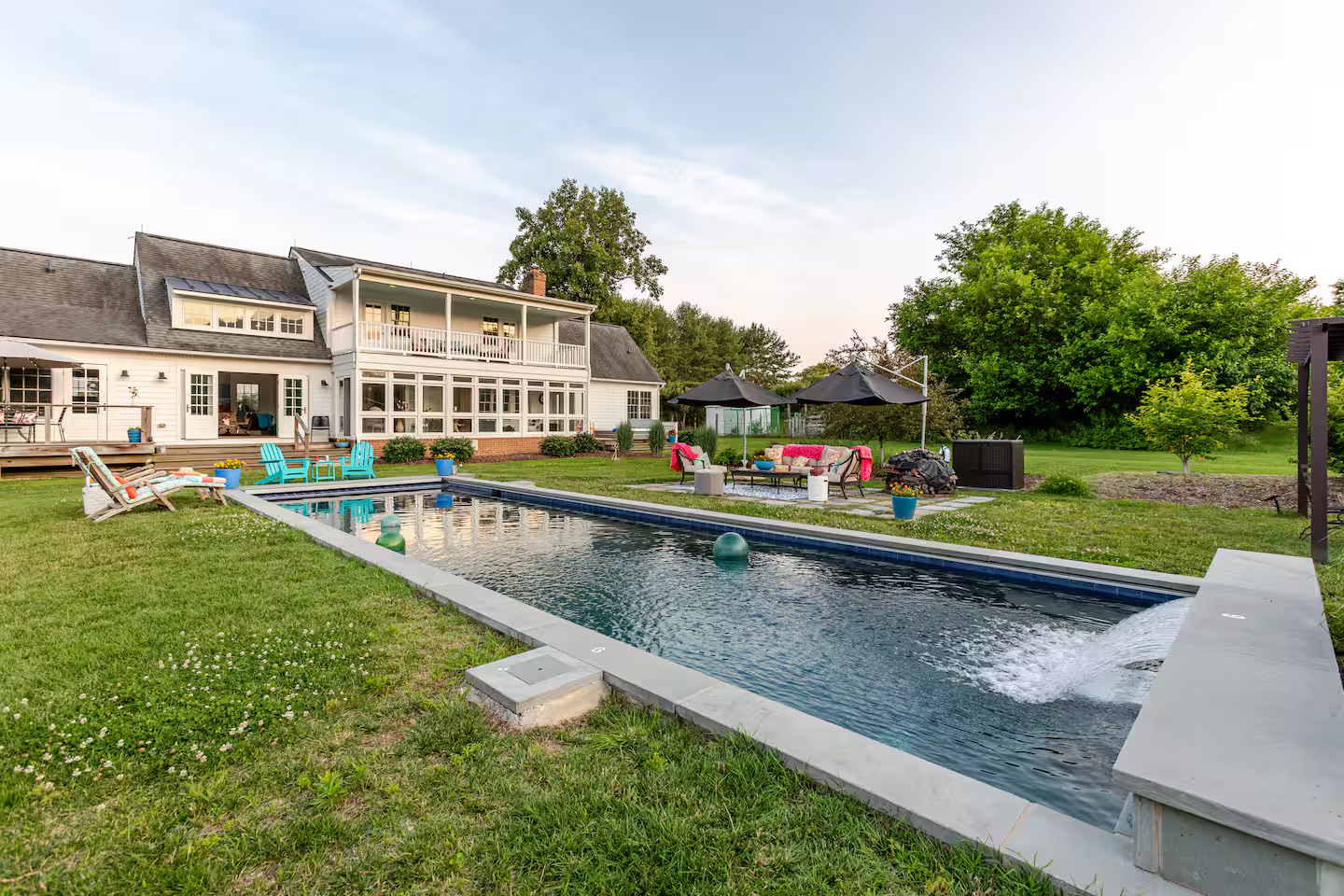 Long pool with waterfall behind the farmhouse - Sunset Farm Stay Vacation Rental
